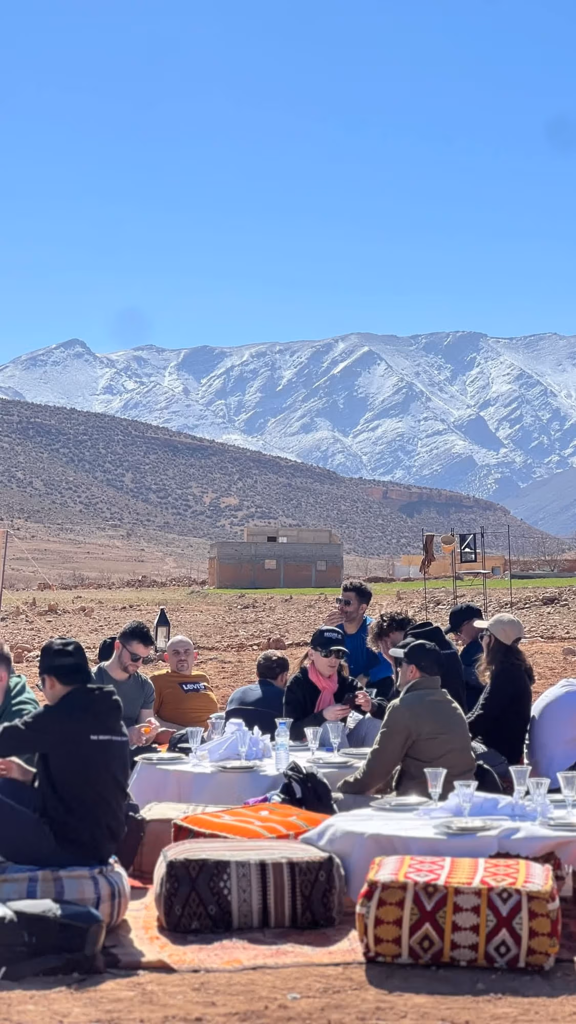 A long table laid for lunch below the snowy High Atlas