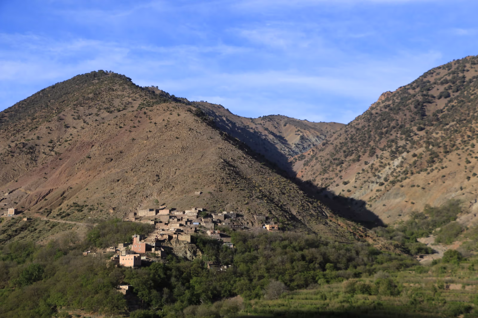 A conical Atlas peak above a Berber village and its terraced fields